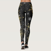 Goldene Schneeflocken auf schwarzem Hintergrund Leggings (Rückseite)