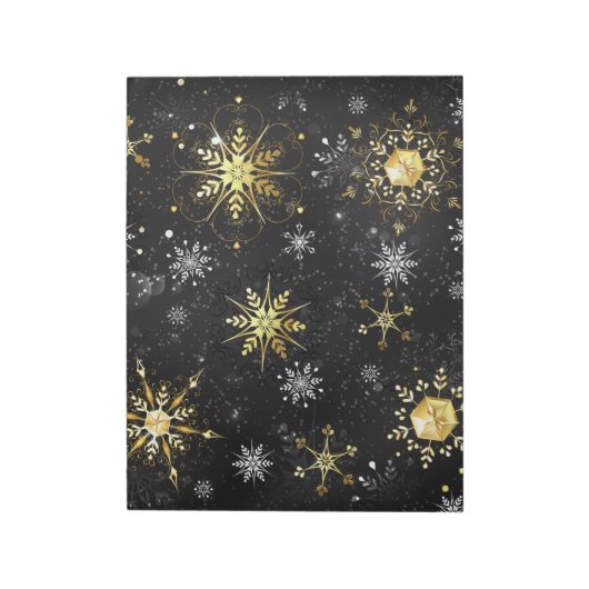Goldene Schneeflocken auf schwarzem Hintergrund Notizblock (Rotiert)