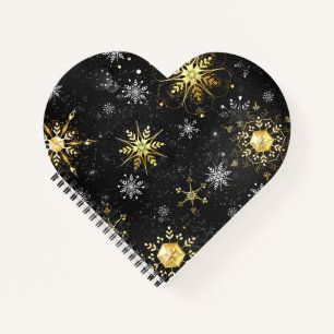 Goldene Schneeflocken auf schwarzem Hintergrund Notizblock