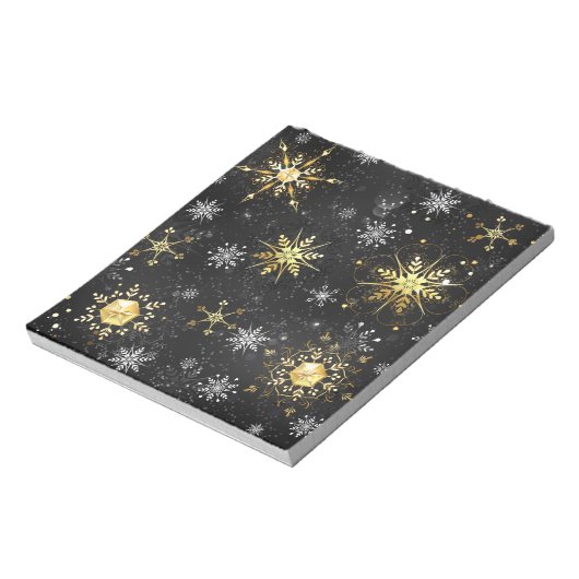 Goldene Schneeflocken auf schwarzem Hintergrund Notizblock (Rotiert)