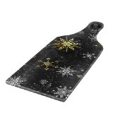 Goldene Schneeflocken auf schwarzem Hintergrund Schneidebrett (Ecke)