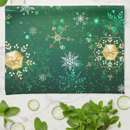 Goldene Schneeflocken im grünen Hintergrund Geschirrtuch (Gefaltet)