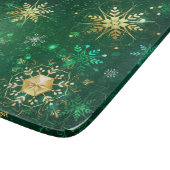 Goldene Schneeflocken im grünen Hintergrund Schneidebrett (Ecke)