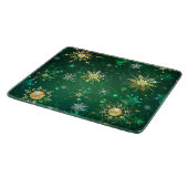 Goldene Schneeflocken im grünen Hintergrund Schneidebrett (Ecke)
