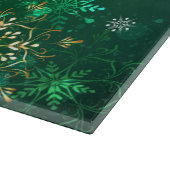 Goldene Schneeflocken im grünen Hintergrund Schneidebrett (Ecke)