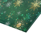 Goldene Schneeflocken im grünen Hintergrund Schneidebrett (Ecke)