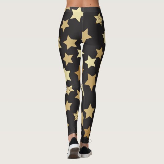 Goldene Sterne auf schwarzem Hintergrund Leggings (Rückseite)