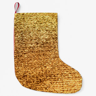 Goldene Textilien: glamouröser Makro-Hintergrund. Kleiner Weihnachtsstrumpf