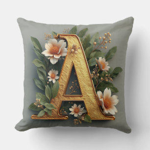 Goldener Buchstabe A umgeben von floralen Arrangem Kissen