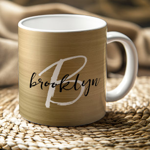Goldener gebürsteter Metall-Schwarz-Weiß-Schrift-M Kaffeetasse