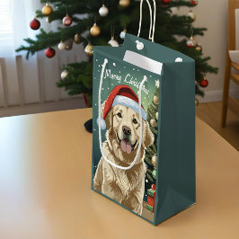 Goldener Retriever in einer Weihnachtsmannmütze Kleine Geschenktüte