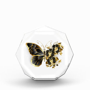 Goldener Schmetterling mit schwarzem Orchid Fotoblock