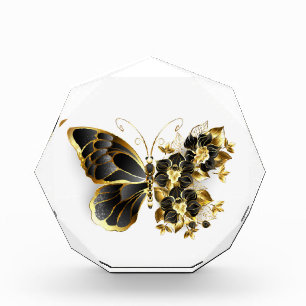 Goldener Schmetterling mit schwarzem Orchid Fotoblock