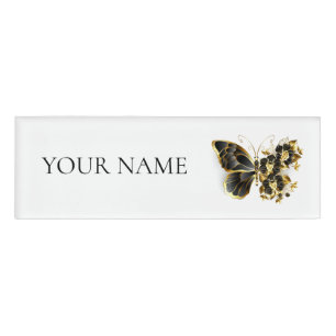 Goldener Schmetterling mit schwarzem Orchid Namenschild