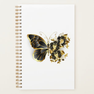 Goldener Schmetterling mit schwarzem Orchid Planer