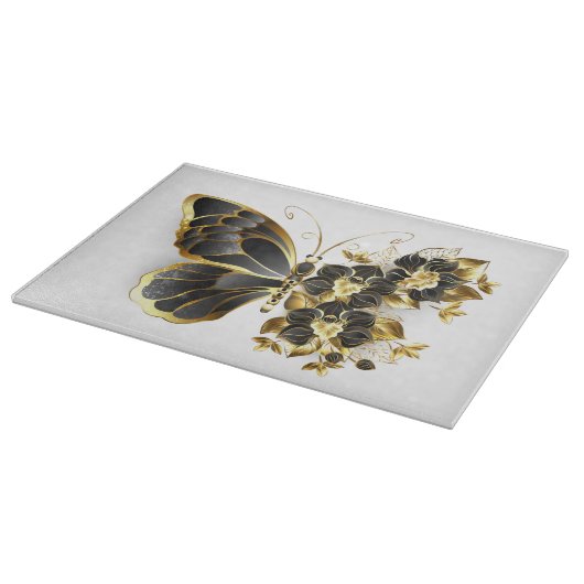 Goldener Schmetterling mit schwarzem Orchid Schneidebrett (Ecke)