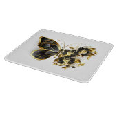 Goldener Schmetterling mit schwarzem Orchid Schneidebrett (Ecke)