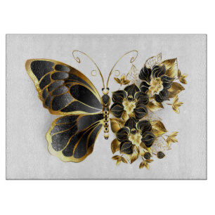 Goldener Schmetterling mit schwarzer Orchidee Schneidebrett