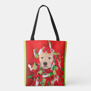Goldener Welpe verwirrt in der Weihnachtsgirlande Tasche