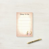 Goldenes Horseshoe mit Blume, was nach dem Ende zu Post-it Klebezettel (Auf Schreibtisch)