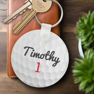 Golf Ball Dimples mit schwarzem Namen Schlüsselanhänger