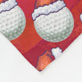 Golf Ball in Weihnachtsmannmütze Muster auf Rot Fleecedecke (Ecke)