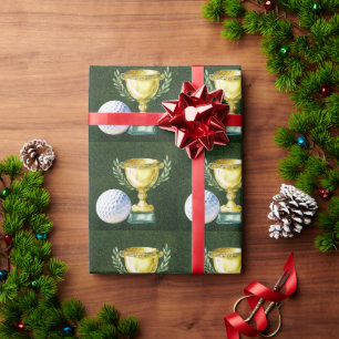 Golfball mit goldener Tasse auf grünem Gras Geschenkpapier