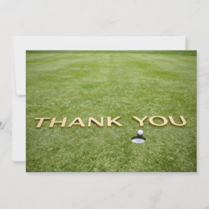 Golfball mit Text Danke auf grünem Gras