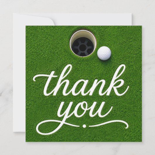 Golfball neben dem Loch Danke auf grünem Gras (Vorderseite)