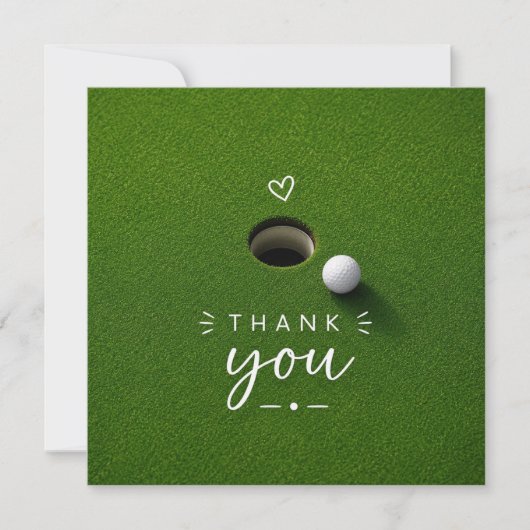 Golfball neben Loch auf grünem Gras Danke (Vorderseite)