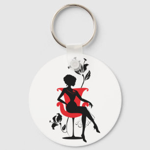 Grafische Silhouette einer Frau, die im roten Stuh Schlüsselanhänger