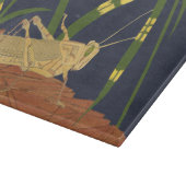 Grasshopper in grünem Gras im blauen Hintergrund Schneidebrett (Ecke)