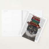 Graue Katze mit Büchern auf Kopf Planer (Anzeige)