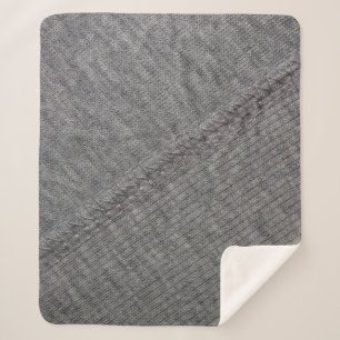 graue Stoffstruktur mit abstrakten Zeichnungen und Sherpadecke