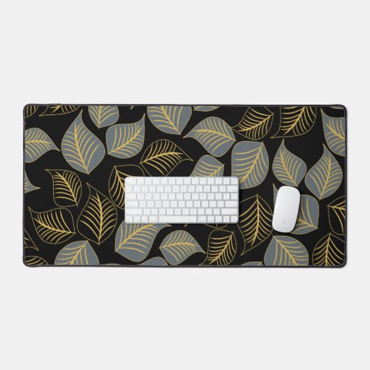 Graue und goldfarbene Blätter auf schwarz Schreibtischunterlage (Tastatur & Maus)
