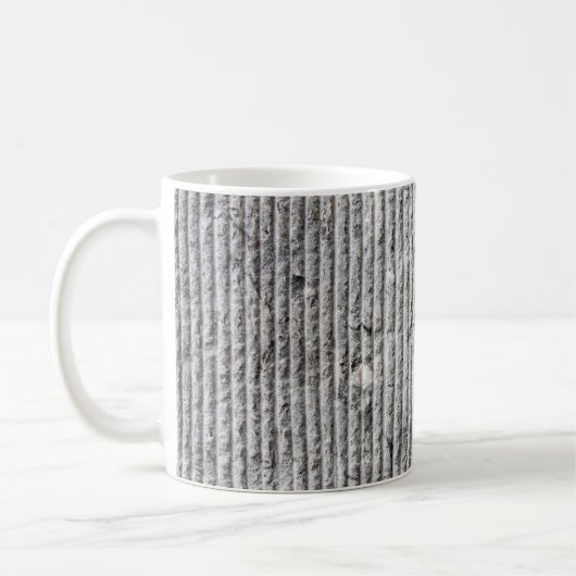 Grausteinfarbene Wandstruktur. Textur der Steinmau Kaffeetasse (Links)
