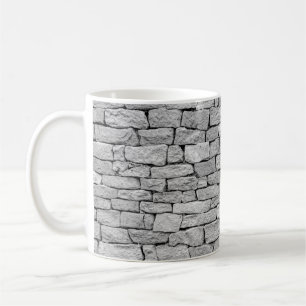 Grausteinmauer als abstrakter Hintergrund. Kaffeetasse