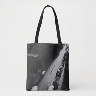 GRAYSCALE FOTO DER PERSON, DIE AUF DER STRASSE NAC TASCHE