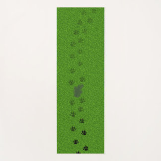 Green grass with dog paw prints and a pee stain yogamatte