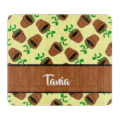 Green plant in terracotta pot on yellow schneidebrett (Vorderseite)