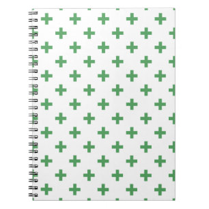 Green polka crosses on white notizblock