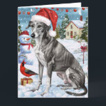 Greyhound Winter Wonderland Christmas Joy Karte<br><div class="desc">Dieses festliche Design spiegelt den fröhlichen Geist der Urlaubssaison wider und besticht durch ein hübsches Jungtier mit einer Weihnachtsmannmütze. Der Hund ist eingebettet in ein winterliches Wunderland, mit einem Schneemann, einem dekorierten Weihnachtsbaum und wunderschön verpackten Geschenken. Schneeflocken fallen sanft ab und geben der Szene eine magische Touch, während die lebhaften...</div>