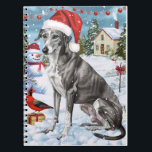 Greyhound Winter Wonderland Christmas Joy Notizblock<br><div class="desc">Dieses festliche Design spiegelt den fröhlichen Geist der Urlaubssaison wider und besticht durch ein hübsches Jungtier mit einer Weihnachtsmannmütze. Der Hund ist eingebettet in ein winterliches Wunderland, mit einem Schneemann, einem dekorierten Weihnachtsbaum und wunderschön verpackten Geschenken. Schneeflocken fallen sanft ab und geben der Szene eine magische Touch, während die lebhaften...</div>