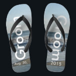 Groom Ocean Waves Beach Sand Badesandalen<br><div class="desc">Hübscher blauer Himmel mit leicht flauschigen weißen Wolken, blaues Meer, abstürzenden Ozeanwellen und Strand Sand. Unisex Flip Flops mit Groom und Datum der Ehe geschrieben in einer weißen Farbe Text. PERSONALISIEREN Sie mit Ihrem Hochzeitstag (oder löschen Sie Text). Der Hochzeitstag ist im Sand geschrieben. Mit breiten schwarzen Straps und schwarzem...</div>