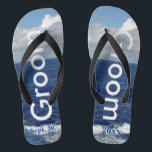 Groom Ocean Waves Blue Sky Badesandalen<br><div class="desc">Einmalige Groom Flip Flops nach Maß. Hübscher blauer Himmel mit flauschigen weißen Wolken, blauem Meer und weißen Schaumwellen. Unisex Flip Flops mit Groom geschrieben in hellem Silber Text, und Datum der Ehe in blauem Text. PERSONALISIEREN Sie mit Ihrem Hochzeitstag (oder löschen Sie Text). Mit Wide Black Straps und Black Footbed...</div>