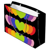 Große schwarze Tasche mit Regenbogenfarben - Herz Geschenktüte (Rückseite Schrägansicht)
