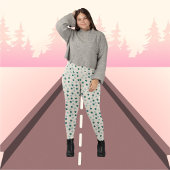 Grüne Blätter auf beigefarbenem Hintergrund Muster Leggings