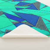 Grüne dreieckige Ausschnitte auf blauem Hintergrun Sherpadecke (3/4)