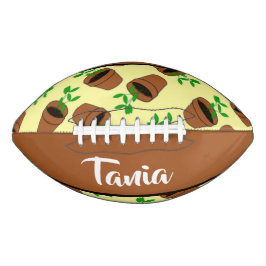 Grüne Pflanze aus Terrakotta auf gelb Football