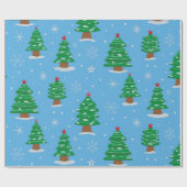 Grüne Weihnachtsbäume mit fallendem Schnee auf bla Geschenkpapier (Flach)